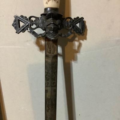 Sale Photo Thumbnail #219: This is a great religious sword with etched s blade and cross.