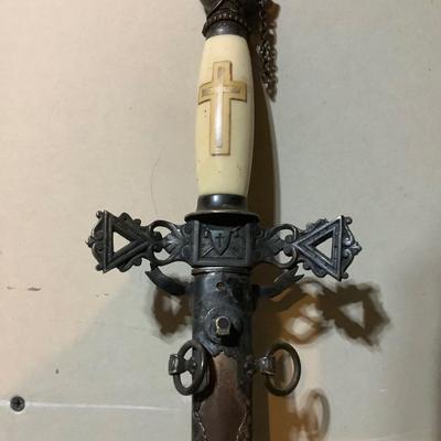 Sale Photo Thumbnail #216: This is a great religious sword with etched s blade and cross.