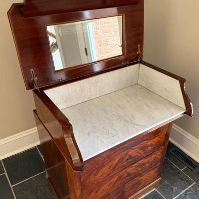 Sale Photo Thumbnail #78: Antique 1850's French Louis Phillippe Dressing Table or Wash Bin with Hinged Lid that opens to a Mirror & Marble Interior. Hand Jointed Detail. Mahogany Veneer.
Approximate Size; 31" x 15" x 36"
“In great condition with general wear consistent with age 