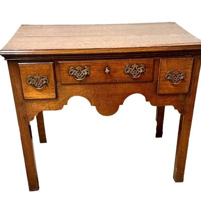 Sale Photo Thumbnail #174: Antique Oak Wood 3 Drawer Lowboy Dressing Table England Circa 1770  32" x 20" x 28"
In good antique condition with marks consistent with use especially on top. Crack in a drawer and divot in leg. Nice sturdy piece. Please see photos.