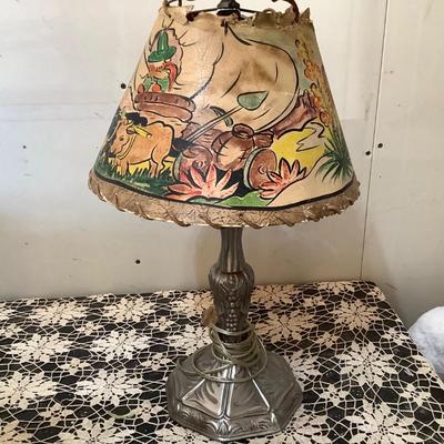 Sale Photo Thumbnail #96: This is a great pop metal table lamp with child’s western scene lamp shade.  Lamp shade has damage. Has newer cord