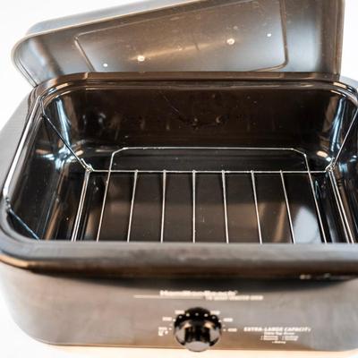 Sale Photo Thumbnail #63: It bakes, roast, slow cooks, steams, and keeps food warm. The temperatures are adjustable. The removable pan makes it easy for cleanup. It is large enough to cook a substantial turkey.