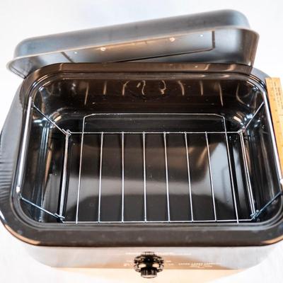 Sale Photo Thumbnail #64: It bakes, roast, slow cooks, steams, and keeps food warm. The temperatures are adjustable. The removable pan makes it easy for cleanup. It is large enough to cook a substantial turkey.