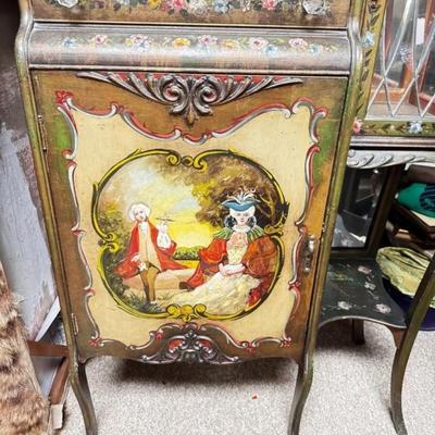 Sale Photo Thumbnail #397: Antique Hand-Painted French Victorian Style Cabinet W/ Glass Doors & Mirror
• Features intricate hand-painted designs and floral motifs
• Includes beveled mirror and glass-paneled doors
• Sturdy wood construction for durability
• Ample storage wit
