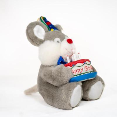 Sale Photo Thumbnail #175: Stuffed mouse with grey and white fur, large ears, and a red nose. Its wearing a colorful party hat and bow.