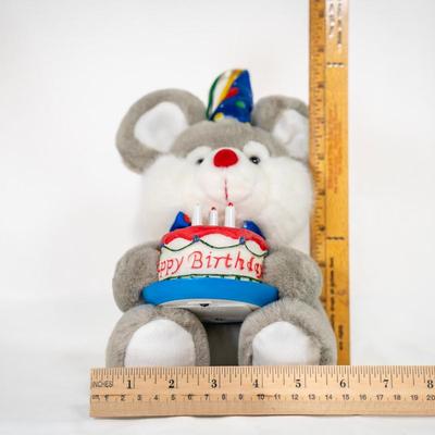 Sale Photo Thumbnail #178: Stuffed mouse with grey and white fur, large ears, and a red nose. Its wearing a colorful party hat and bow.
