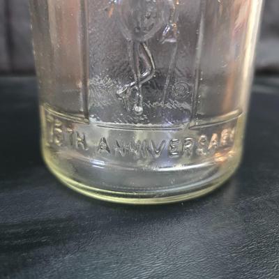 vintage 1981 Planters Mr. Peanut 75th Anniversary glass jar with three square glass apothecary jars, often used as kitchen canisters.