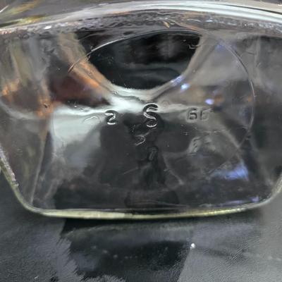 vintage 1981 Planters Mr. Peanut 75th Anniversary glass jar with three square glass apothecary jars, often used as kitchen canisters.