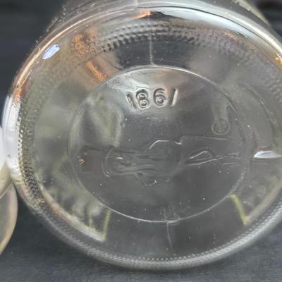 vintage 1981 Planters Mr. Peanut 75th Anniversary glass jar with three square glass apothecary jars, often used as kitchen canisters.