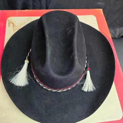 Black felt American Hat Company cowboy hat with a braided hatband with white tassels, with its original box. Size 7 1/4 comes with a hat...