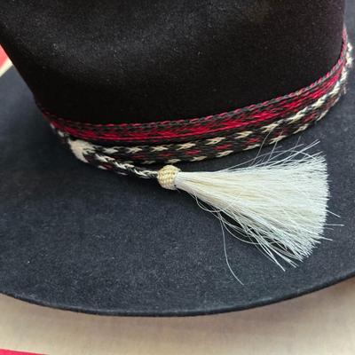 Black felt American Hat Company cowboy hat with a braided hatband with white tassels, with its original box. Size 7 1/4 comes with a hat...