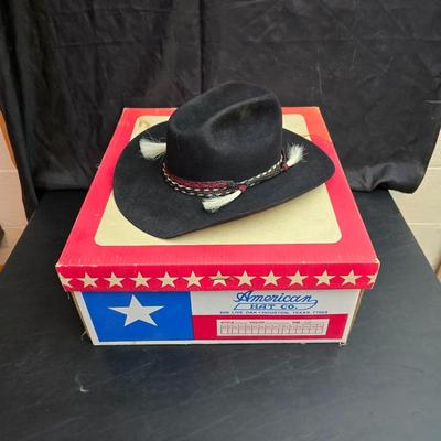 Black felt American Hat Company cowboy hat with a braided hatband with white tassels, with its original box. Size 7 1/4 comes with a hat...