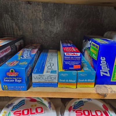 Large assortment of Kitchen must haves - bags - paper plates - plastic flatware and a Leifheit kitchen roll holder