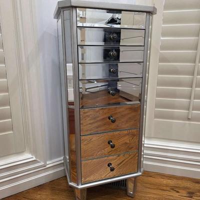 Sale Photo Thumbnail #68: This gorgeous, mirrored jewelry armoire will make a perfect gift for the holidays! The top lifts, the sides open and it has 7 drawers of varying sizes to accommodate all kinds of treasured jewels. This piece is in great condition and measures 32"H x 18"W 