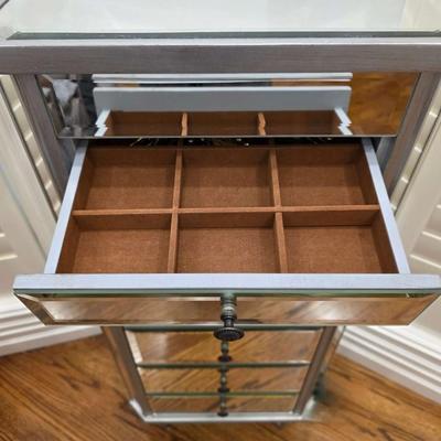Sale Photo Thumbnail #71: This gorgeous, mirrored jewelry armoire will make a perfect gift for the holidays! The top lifts, the sides open and it has 7 drawers of varying sizes to accommodate all kinds of treasured jewels. This piece is in great condition and measures 32"H x 18"W 