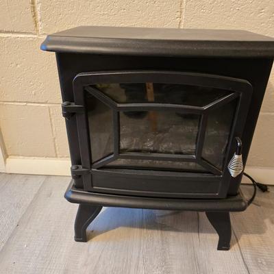 Working Space heater fireplace Model SF57C-17A00 with brown braided throw rug