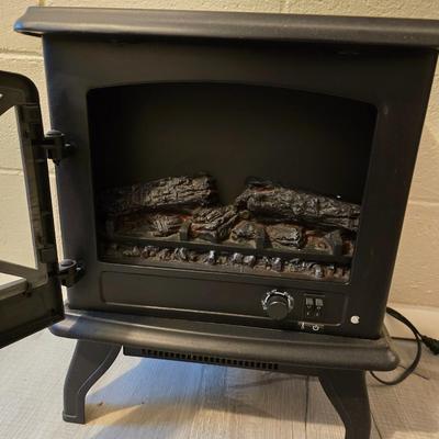 Working Space heater fireplace Model SF57C-17A00 with brown braided throw rug