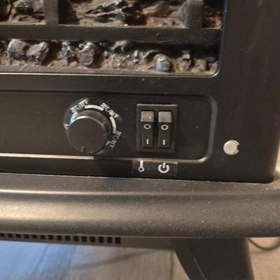 Working Space heater fireplace Model SF57C-17A00 with brown braided throw rug