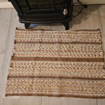 Working Space heater fireplace Model SF57C-17A00 with brown braided throw rug