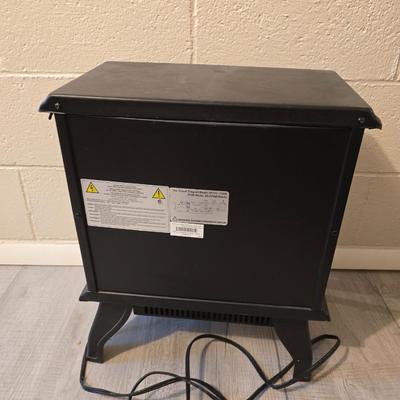 Working Space heater fireplace Model SF57C-17A00 with brown braided throw rug