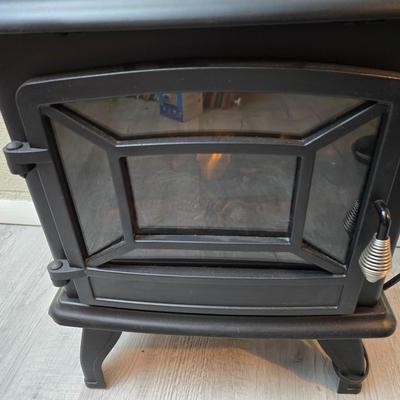 Working Space heater fireplace Model SF57C-17A00 with brown braided throw rug