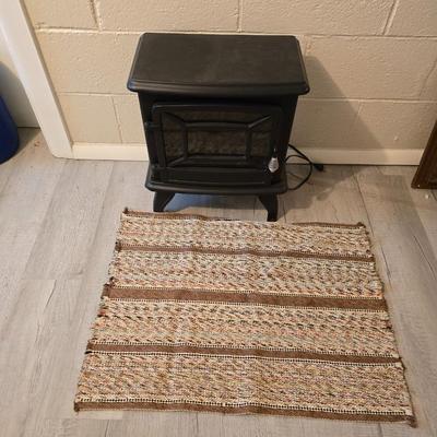 Working Space heater fireplace Model SF57C-17A00 with brown braided throw rug