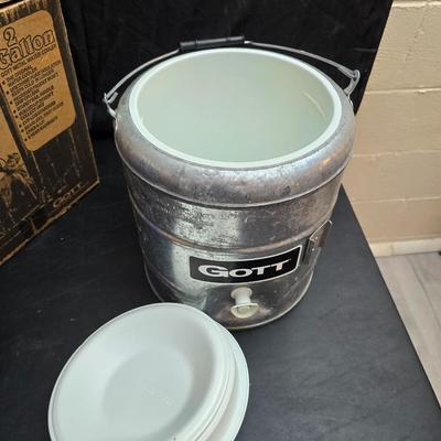 Two vintage Gott water coolers - 2 Gallon metal galvanized water cooler and a 2-gallon Gott blue plastic cooler