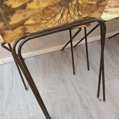 Vintage set of 3 complete fiberglass TV trays from the 1960s, featuring a rustic "Log Cabin" or country scene pattern likely...