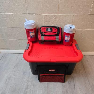 Craftsman storage tote, canvas Craftsman tool bag, red water coolers, and a 3 a day lunch cooler / bag