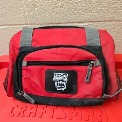 Craftsman storage tote, canvas Craftsman tool bag, red water coolers, and a 3 a day lunch cooler / bag