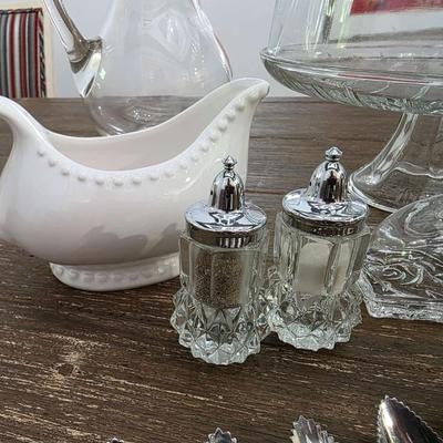 Sale Photo Thumbnail #90: This is a lot including a glass cake stand with dome, glass butter dish, crystal salt and pepper shakers, glass tea pitcher, crystal bud vase, 2 white gravy bowls and 10 grapefruit spoons. These are mostly all unmarked items. You are bidding on the lot me