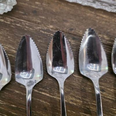 Sale Photo Thumbnail #92: This is a lot including a glass cake stand with dome, glass butter dish, crystal salt and pepper shakers, glass tea pitcher, crystal bud vase, 2 white gravy bowls and 10 grapefruit spoons. These are mostly all unmarked items. You are bidding on the lot me