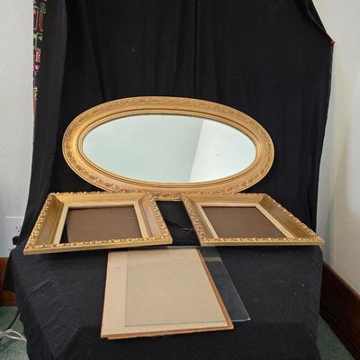 Large oval gold framed mirror with two matching /really close to matching gold decorative picture frames