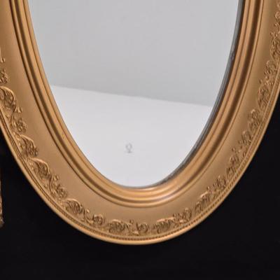 Large oval gold framed mirror with two matching /really close to matching gold decorative picture frames