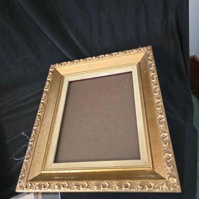 Large oval gold framed mirror with two matching /really close to matching gold decorative picture frames
