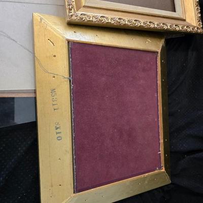 Large oval gold framed mirror with two matching /really close to matching gold decorative picture frames