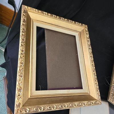 Large oval gold framed mirror with two matching /really close to matching gold decorative picture frames