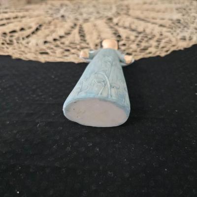 Elegant picture frame with collection of angels, and a large doily