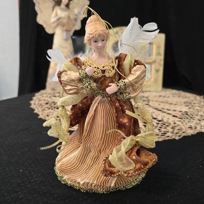 Elegant picture frame with collection of angels, and a large doily