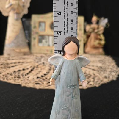 Elegant picture frame with collection of angels, and a large doily