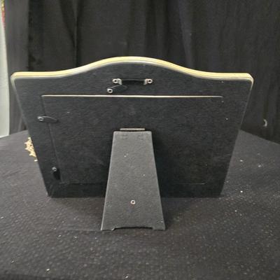 Elegant picture frame with collection of angels, and a large doily