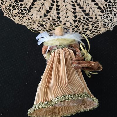 Elegant picture frame with collection of angels, and a large doily