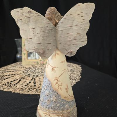 Elegant picture frame with collection of angels, and a large doily