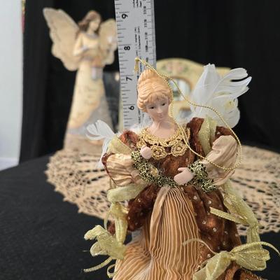 Elegant picture frame with collection of angels, and a large doily