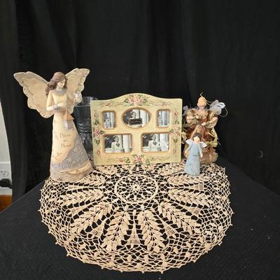 Elegant picture frame with collection of angels, and a large doily
