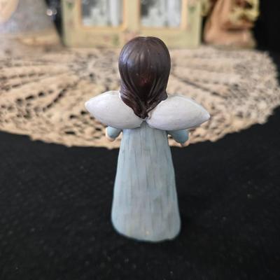 Elegant picture frame with collection of angels, and a large doily