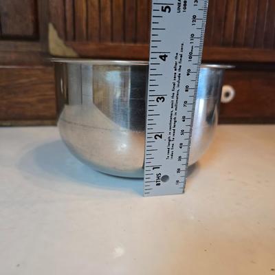 Stainless steel bowls and a strainer with an apron