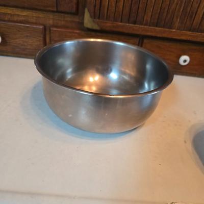 Stainless steel bowls and a strainer with an apron