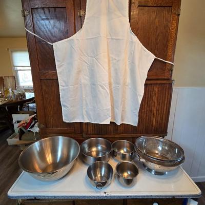 Stainless steel bowls and a strainer with an apron