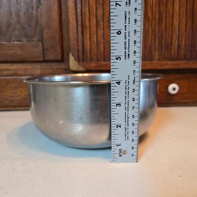 Stainless steel bowls and a strainer with an apron